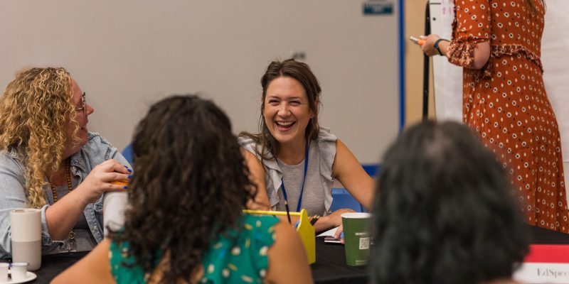 RCS Staff sitting togehter at the staff retreat collaborating.